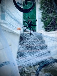 Fake spider webs and a fake spider being used as small apartment Halloween ideas. 